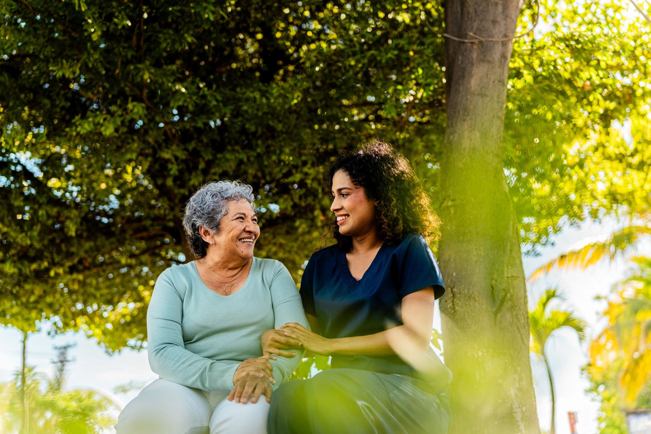 Caregiver supporting a patient outdoors